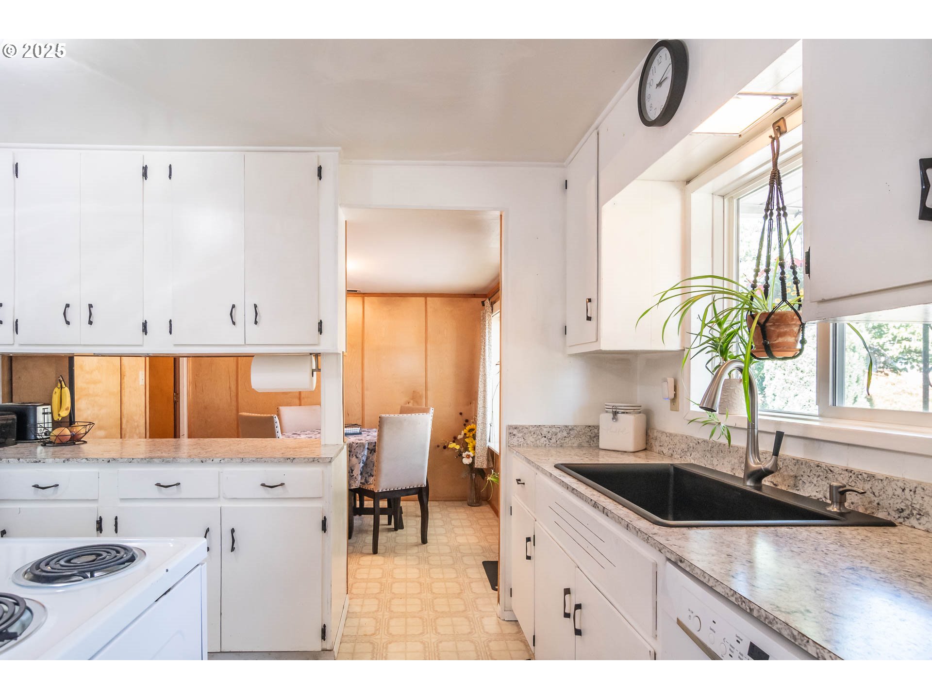 68 Rose Avenue Winston, OR 97496 - Photo 13 of 43 a kitchen with stainless steel appliances a sink a stove and a dining table with wooden floor