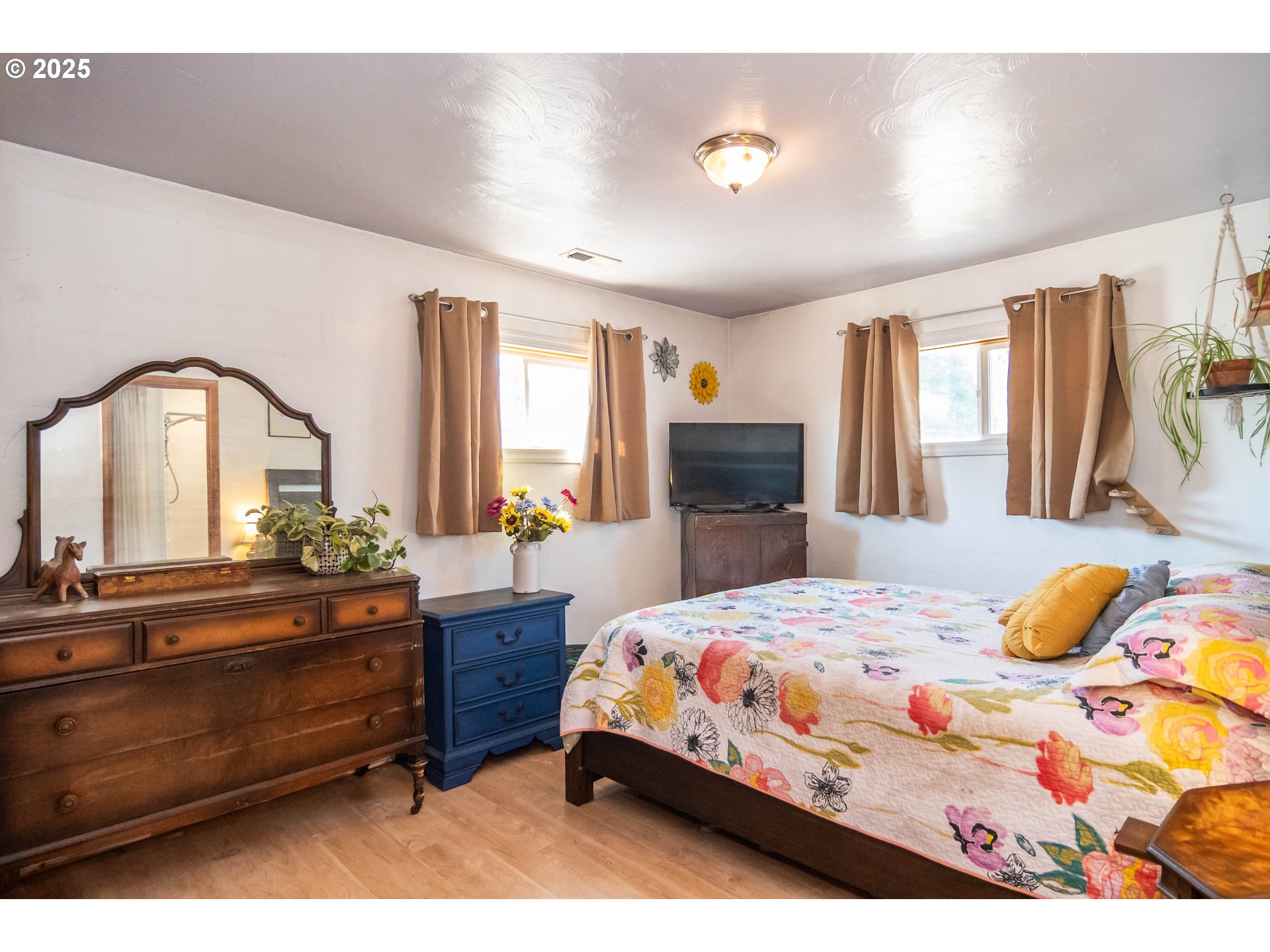 68 Rose Avenue Winston, OR 97496 - Photo 15 of 43 a bedroom with a bed and a dresser with mirror