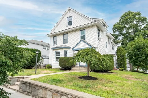 a house that has a tree in front of it