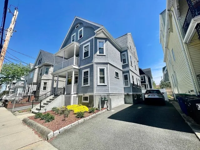a front view of a residential apartment building with a yard