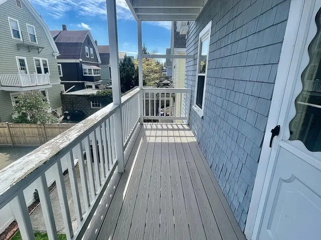 a view of balcony with wooden floor