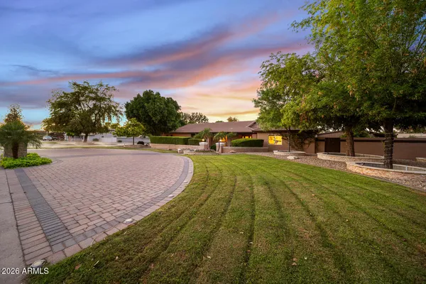 a bedroom with a large bed and a ceiling fan