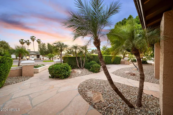 a living room with furniture and a ceiling fan