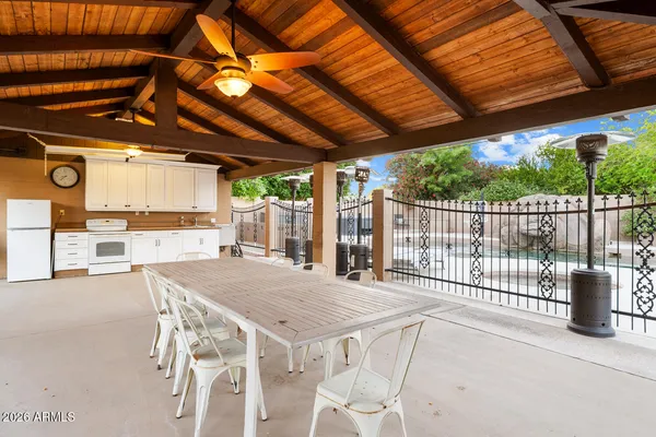 a kitchen with granite countertop center island a wooden floor stainless steel appliances and windows