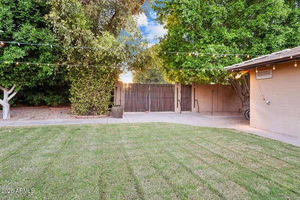 a living room with furniture a fireplace and a dining table with kitchen view