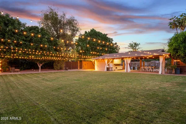 front view of a house with a yard and potted plants