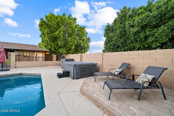 a view of a patio with table and chairs with wooden floor and fence