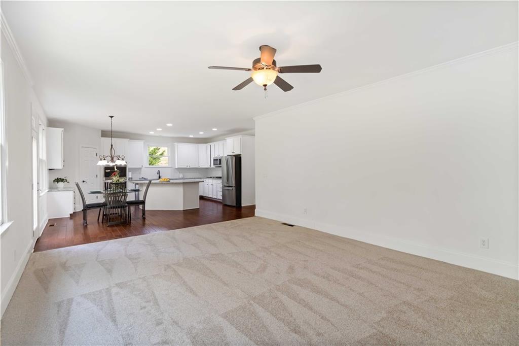 3320 Spencer Street Cumming, GA 30041 - Photo 13 of 90 a view of a workspace with furniture and a ceiling fan