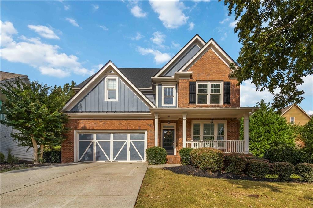 3320 Spencer Street Cumming, GA 30041 - Photo 3 of 90 a front view of a house with a yard and garage