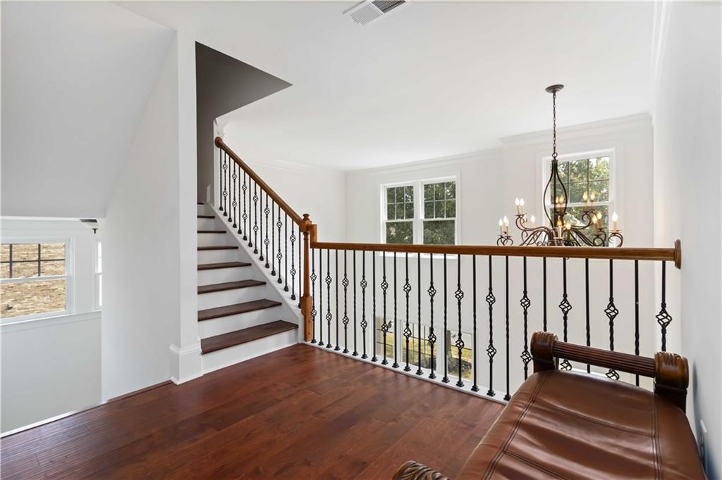 3320 Spencer Street Cumming, GA 30041 - Photo 40 of 90 a view of a hallway with stairs and wooden floor