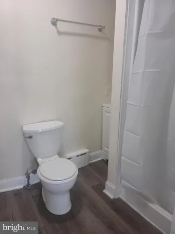 a view of street and car parked on the road