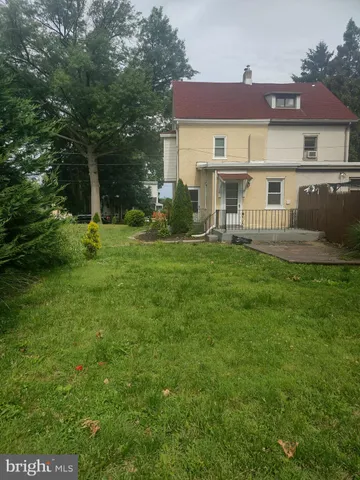 a view of a house with a yard and sitting area