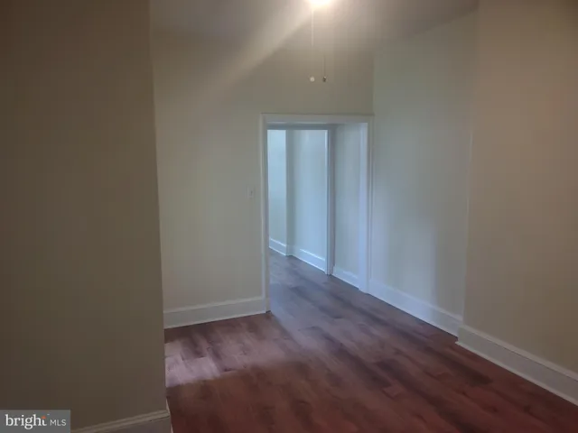 a view of a small space with wooden floor and closet