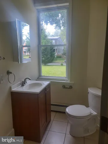 a bathroom with a sink toilet and window