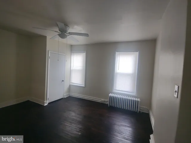 a white toilet sitting next to a shower