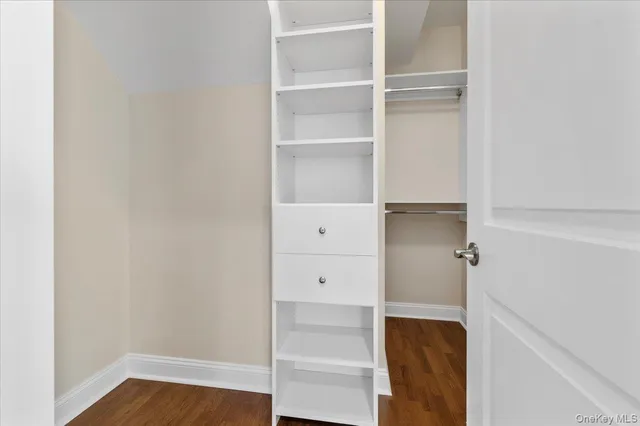 a view of walk in closet with empty racks