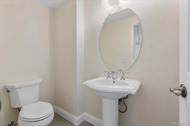 a bathroom with a sink a mirror and a toilet