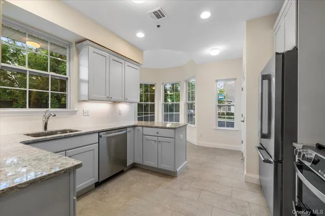 a kitchen with a sink stove and refrigerator