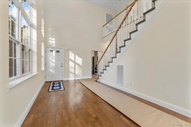 a view of an entryway with wooden floor