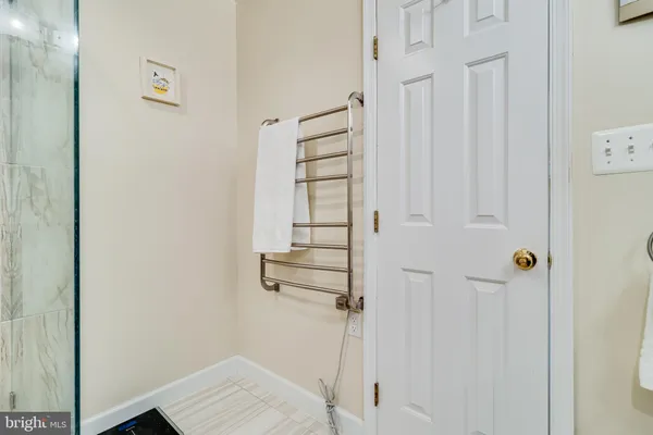 a view of a hallway with wooden floor and living room