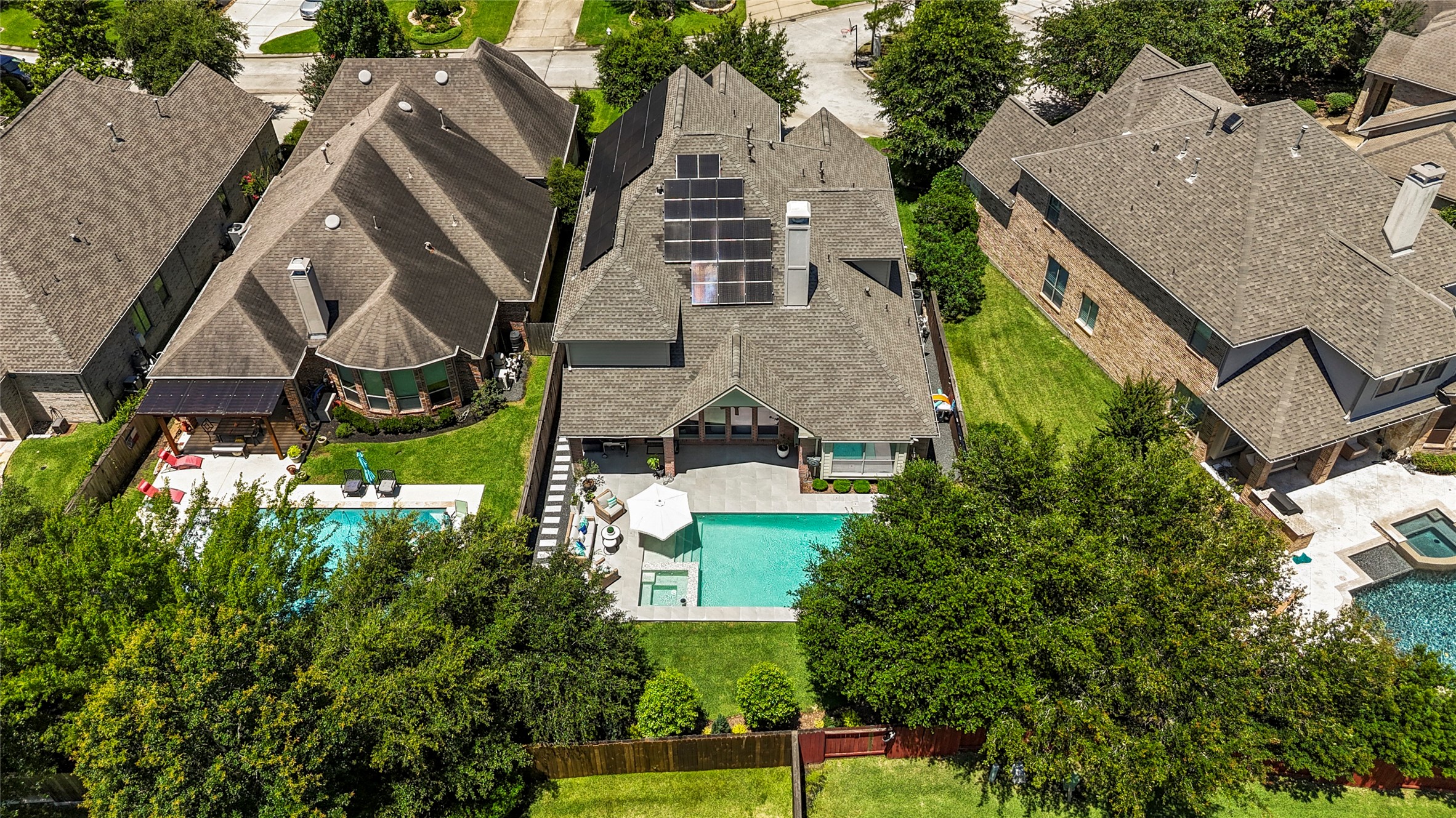 26 Winhall Place The Woodlands, TX 77354 - Photo 47 of 49 Aerial view showcases the beautifully designed backyard pool, spa, outdoor covered patio and Ion Solar Panels for added efficiency.