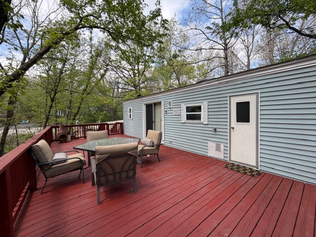 2795 East 28th Road Marseilles, IL 61341 - Photo 16 of 56 a roof deck with table and chairs and wooden floor