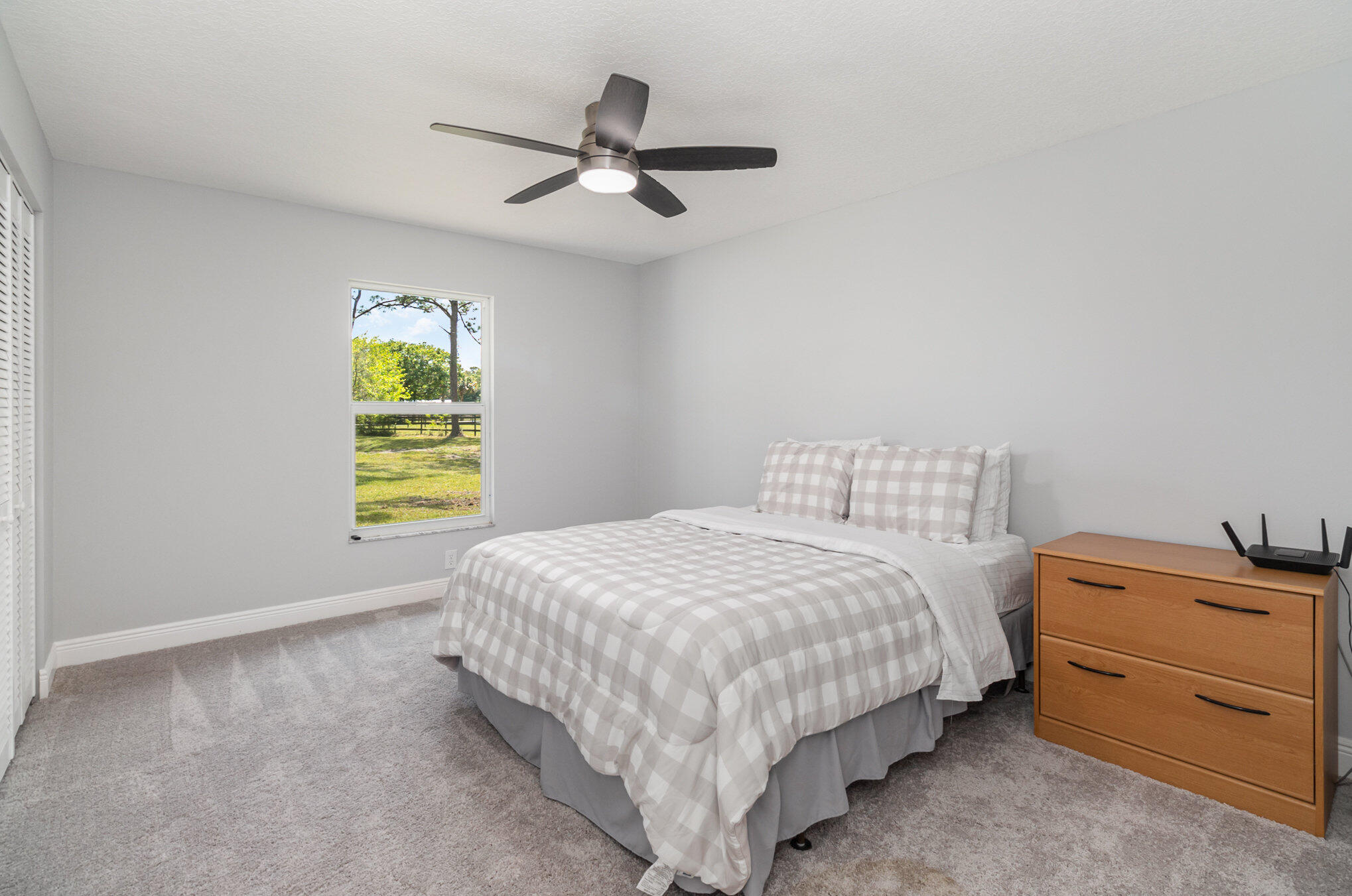 4561 Mustang Road Melbourne, FL 32934 - Photo 20 of 25 a bedroom with a bed and a window