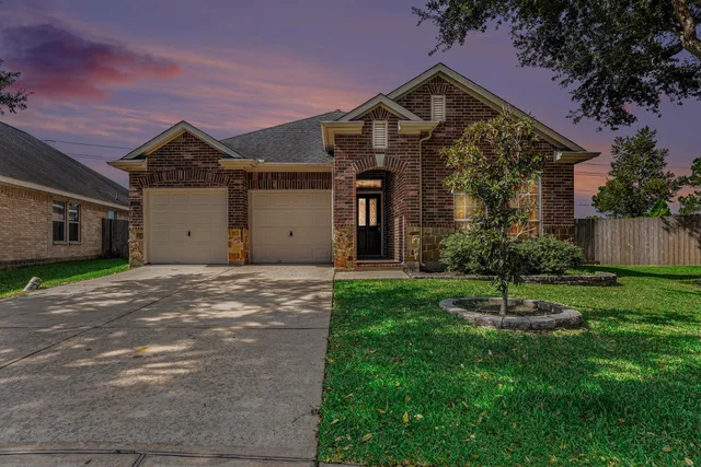 a front view of a house with a yard and a garage