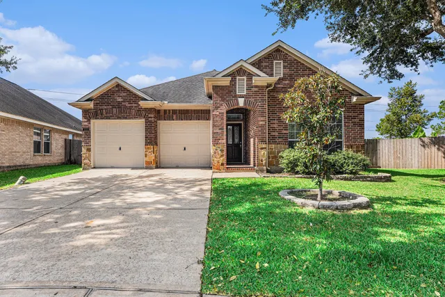 a front view of a house with a yard and a garage