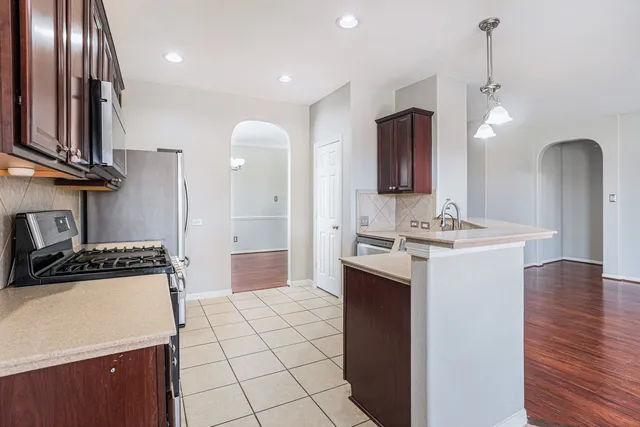 a kitchen with a sink appliances and cabinets
