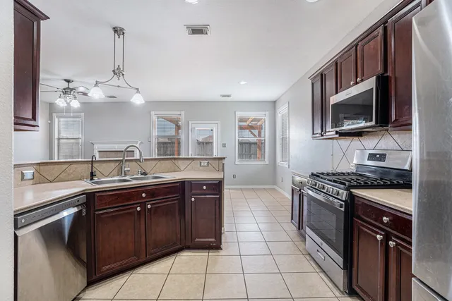 a kitchen with a sink stove and microwave