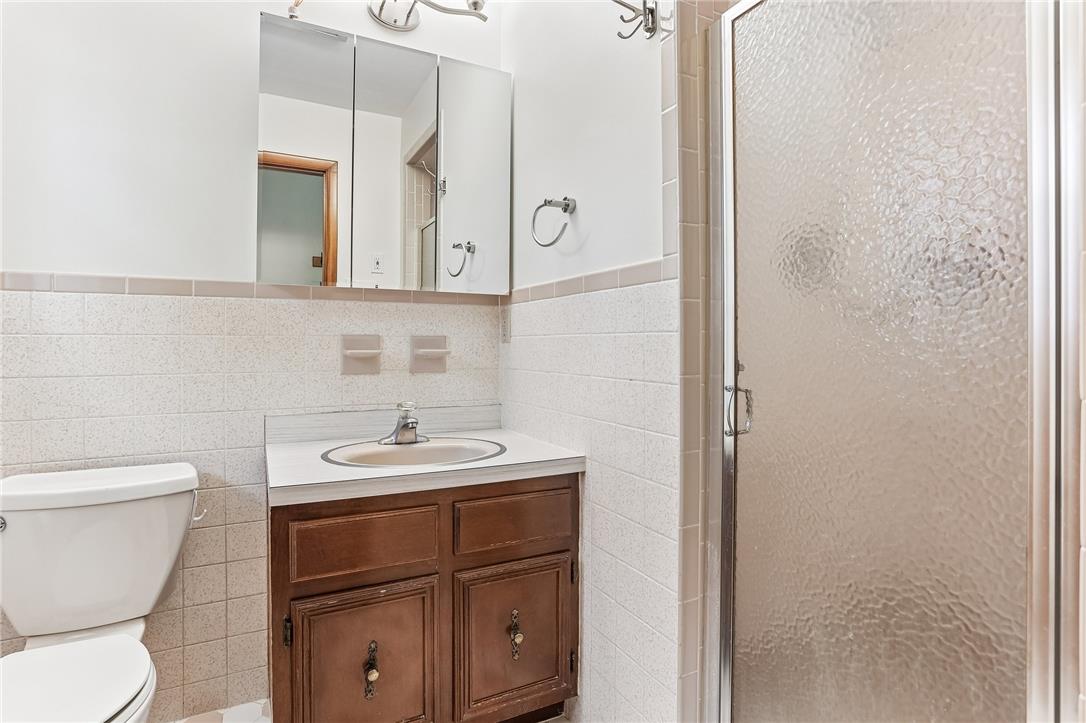 3659 Ironstone Road Bethlehem, PA 18020 - Photo 6 of 52 A well-lit bathroom offers a practical vanity, convenient toilet, and a stand-up shower for daily comfort.