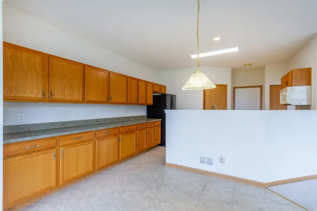 a kitchen with stainless steel appliances granite countertop a sink and cabinets