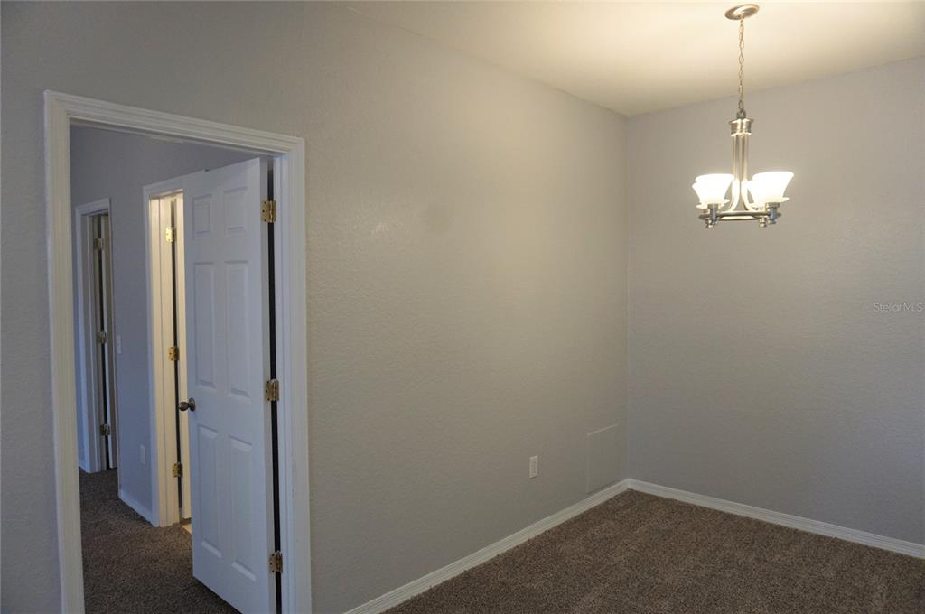 852 Grand Regency Pointe, Unit 205 Altamonte Springs, FL 32714 - Photo 6 of 11 a view of a hallway with chandelier