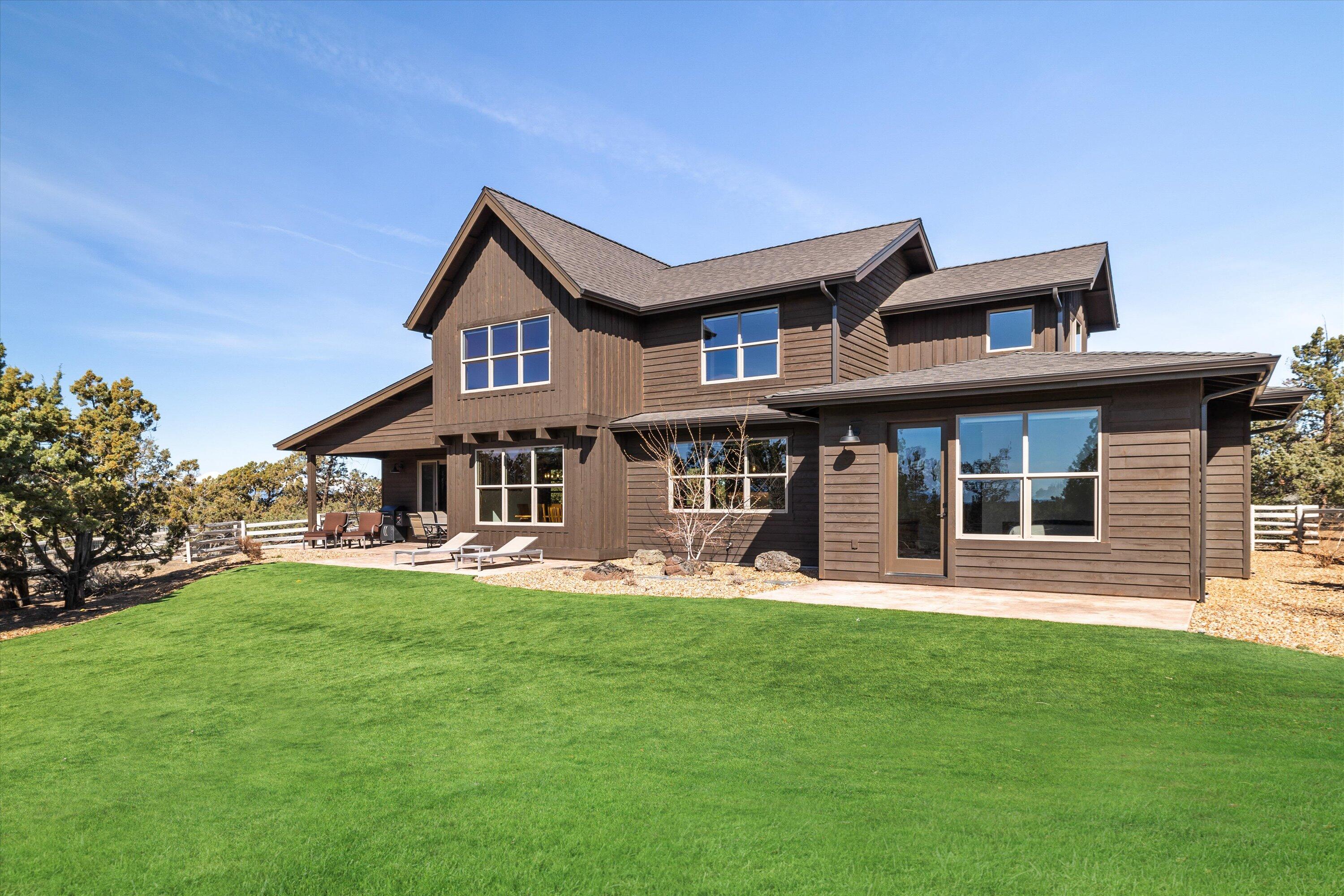 15687 Southwest Brasada Rnch Road Powell Butte, OR 97753 - Photo 52 of 73 a front view of a house with a yard