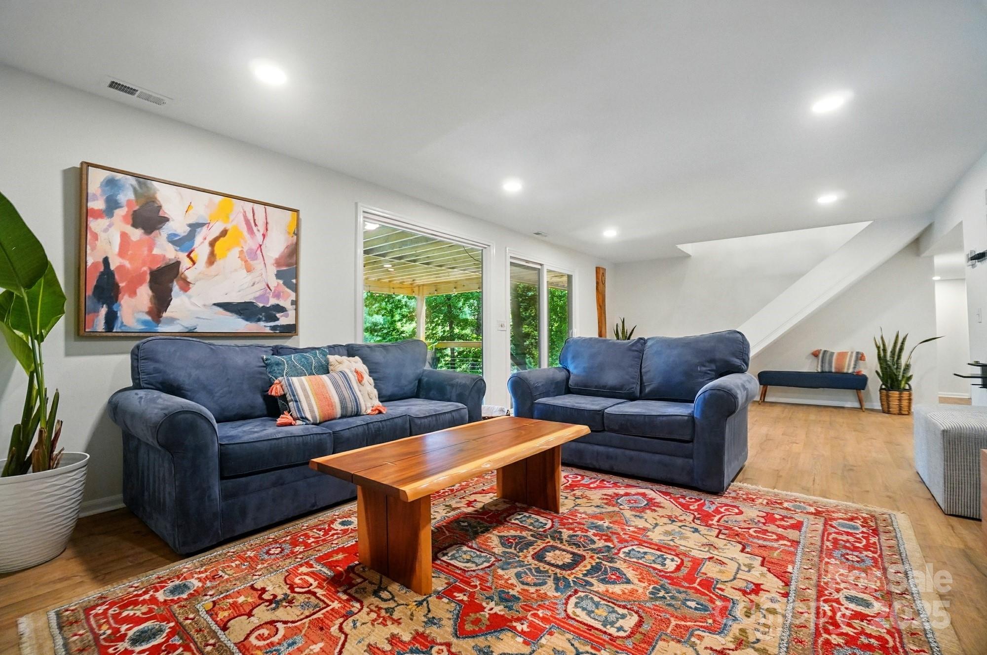 10043 Tepa Place Tega Cay, SC 29708 - Photo 27 of 43 a living room with furniture a rug and a large window