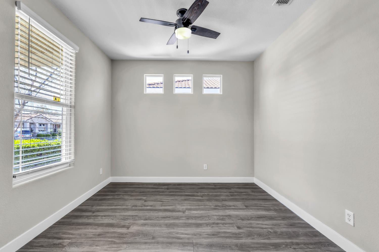 1839 Dawnelle Way Sacramento, CA 95835 - Photo 12 of 56 a view of an empty room with wooden floor and a window