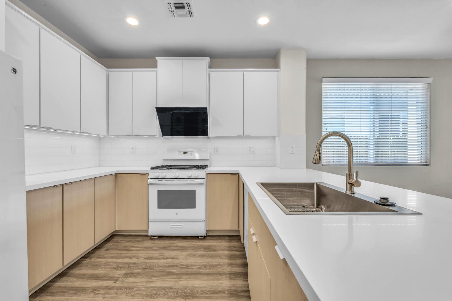 1839 Dawnelle Way Sacramento, CA 95835 - Photo 15 of 56 a kitchen with granite countertop a sink stainless steel appliances and cabinets