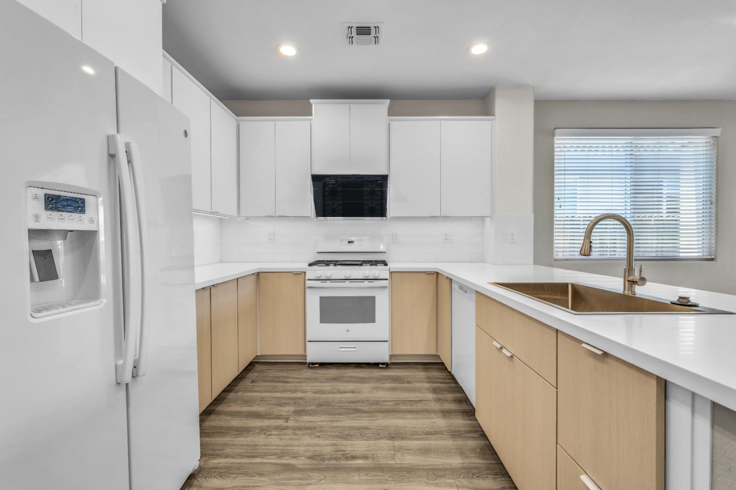 1839 Dawnelle Way Sacramento, CA 95835 - Photo 17 of 56 a kitchen with white cabinets and appliances