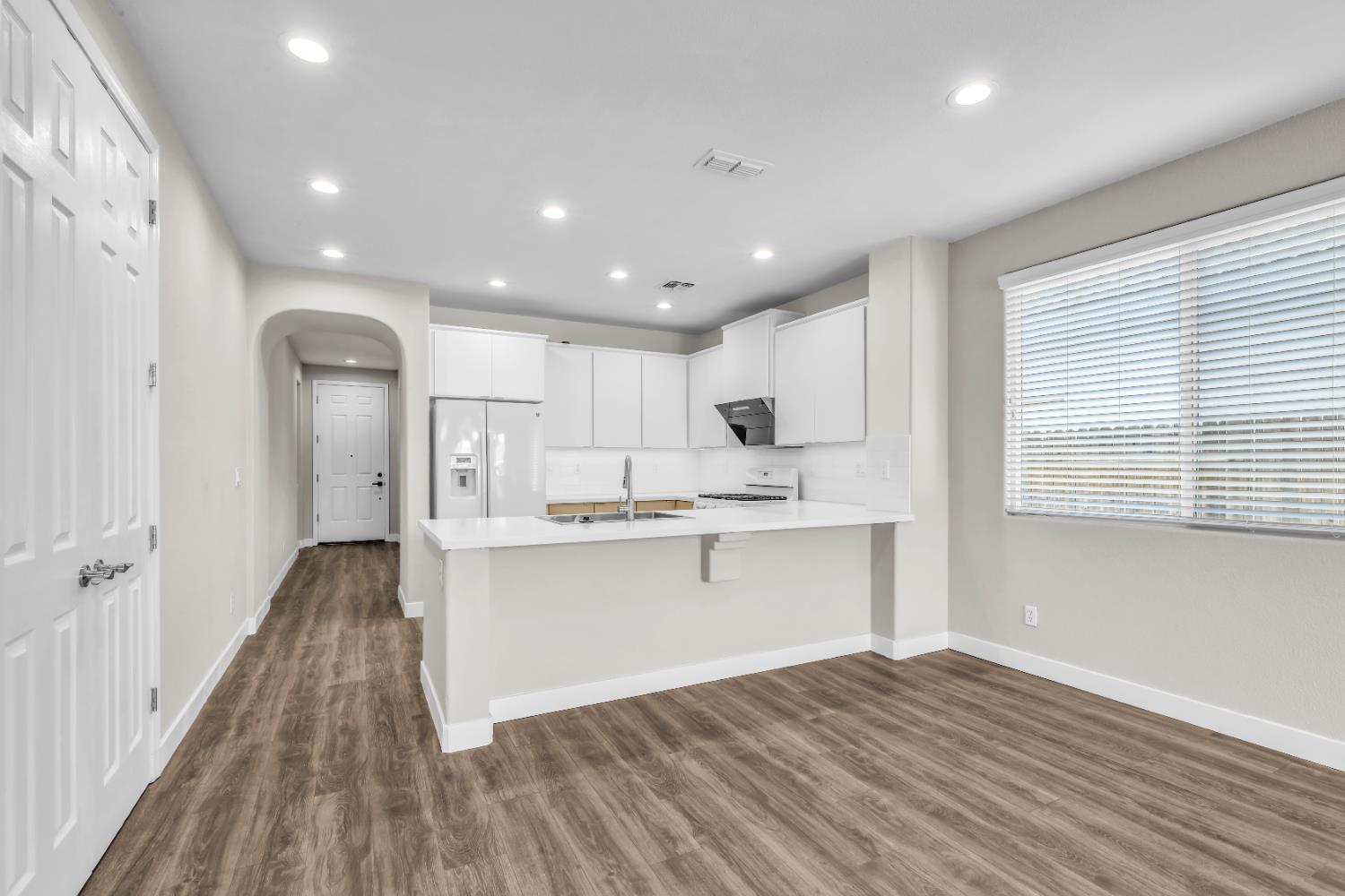 1839 Dawnelle Way Sacramento, CA 95835 - Photo 20 of 56 a kitchen with stainless steel appliances granite countertop a white cabinets and wooden floors