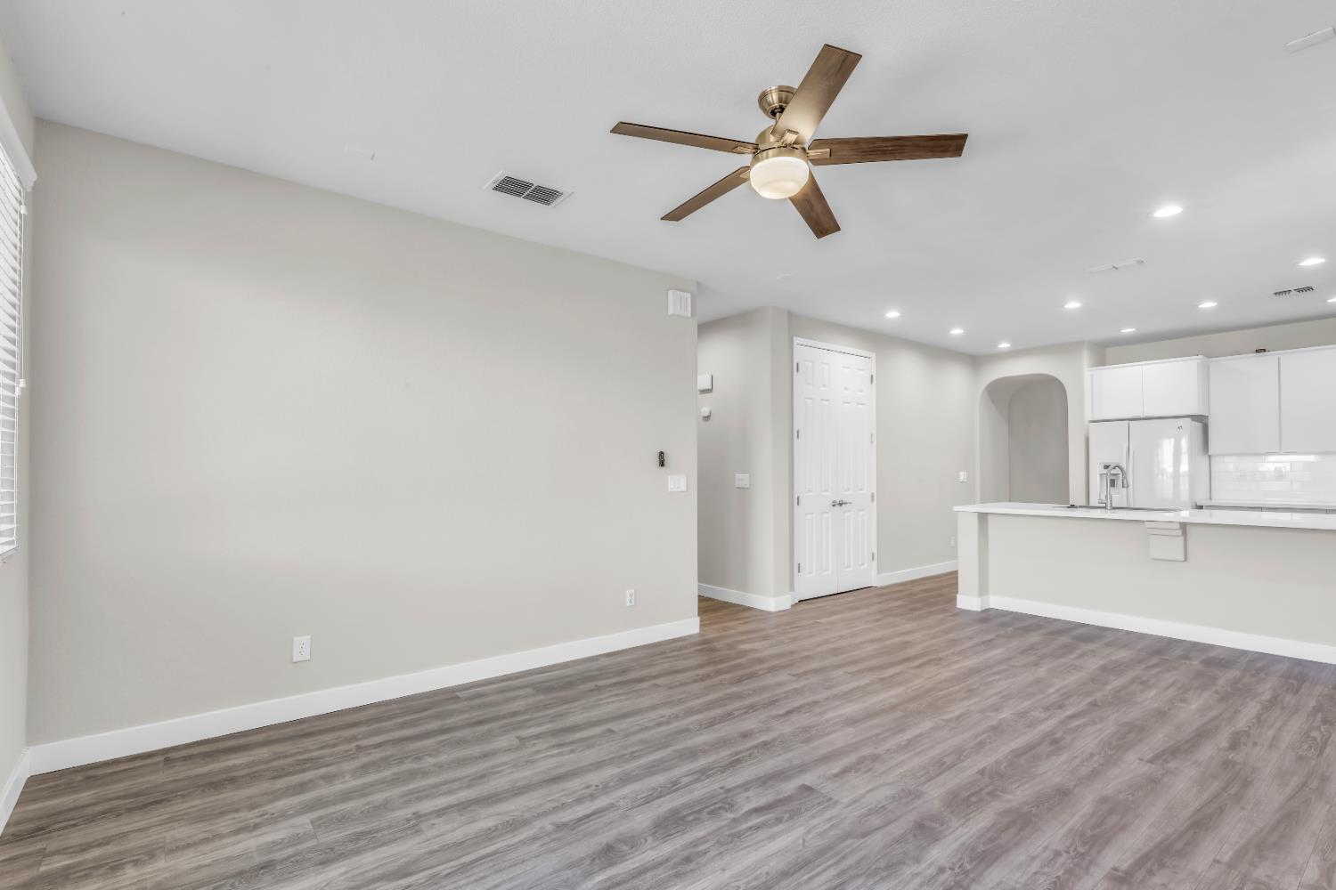 1839 Dawnelle Way Sacramento, CA 95835 - Photo 25 of 56 a view of an empty room and kitchen with wooden floor