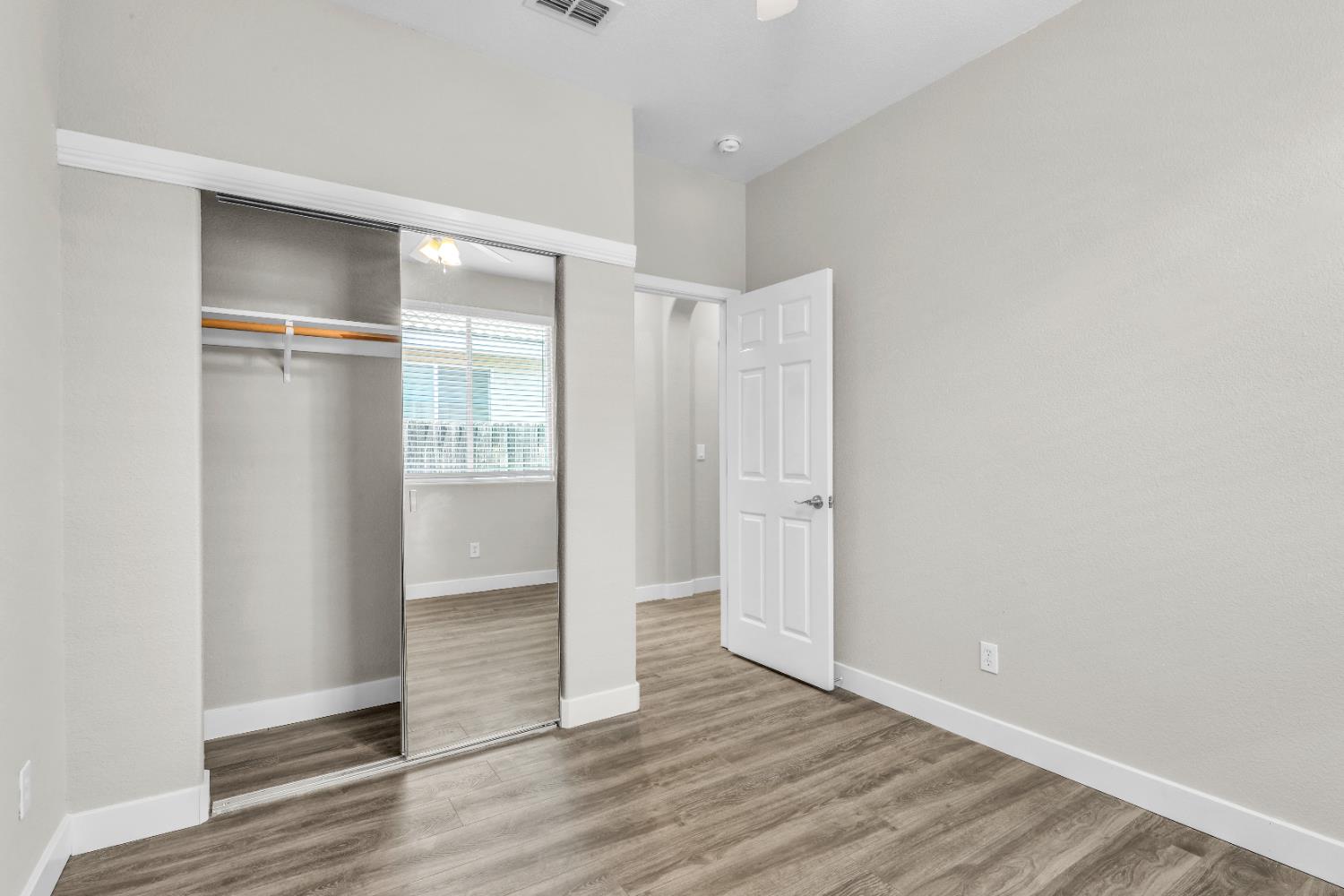1839 Dawnelle Way Sacramento, CA 95835 - Photo 30 of 56 a view of an empty room with wooden floor & window