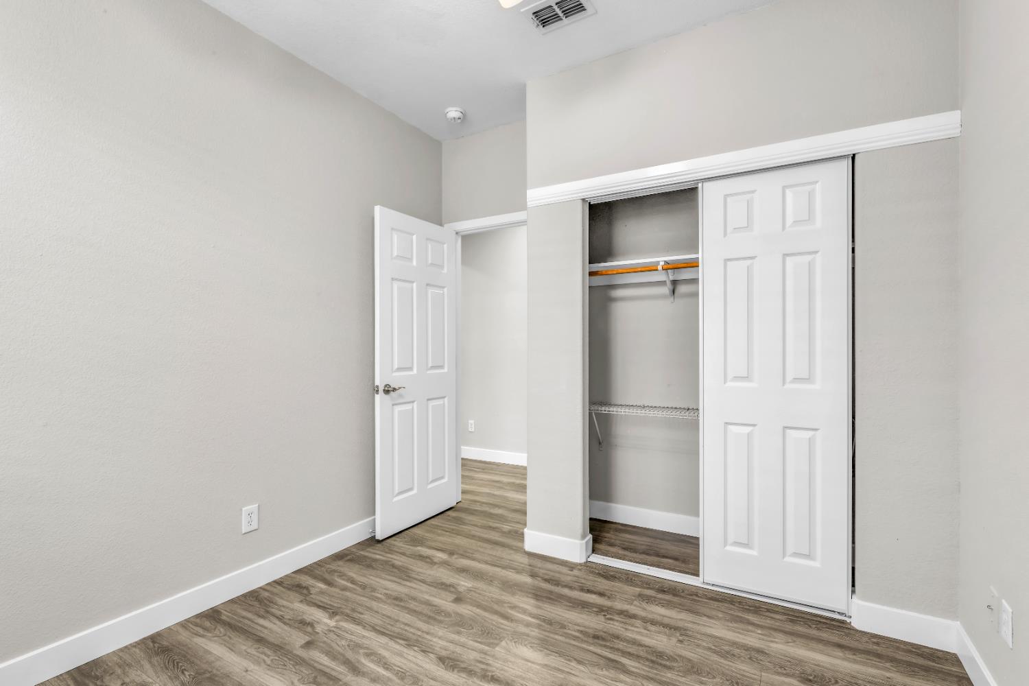 1839 Dawnelle Way Sacramento, CA 95835 - Photo 35 of 56 a view of an empty room with wooden floor and a kitchen