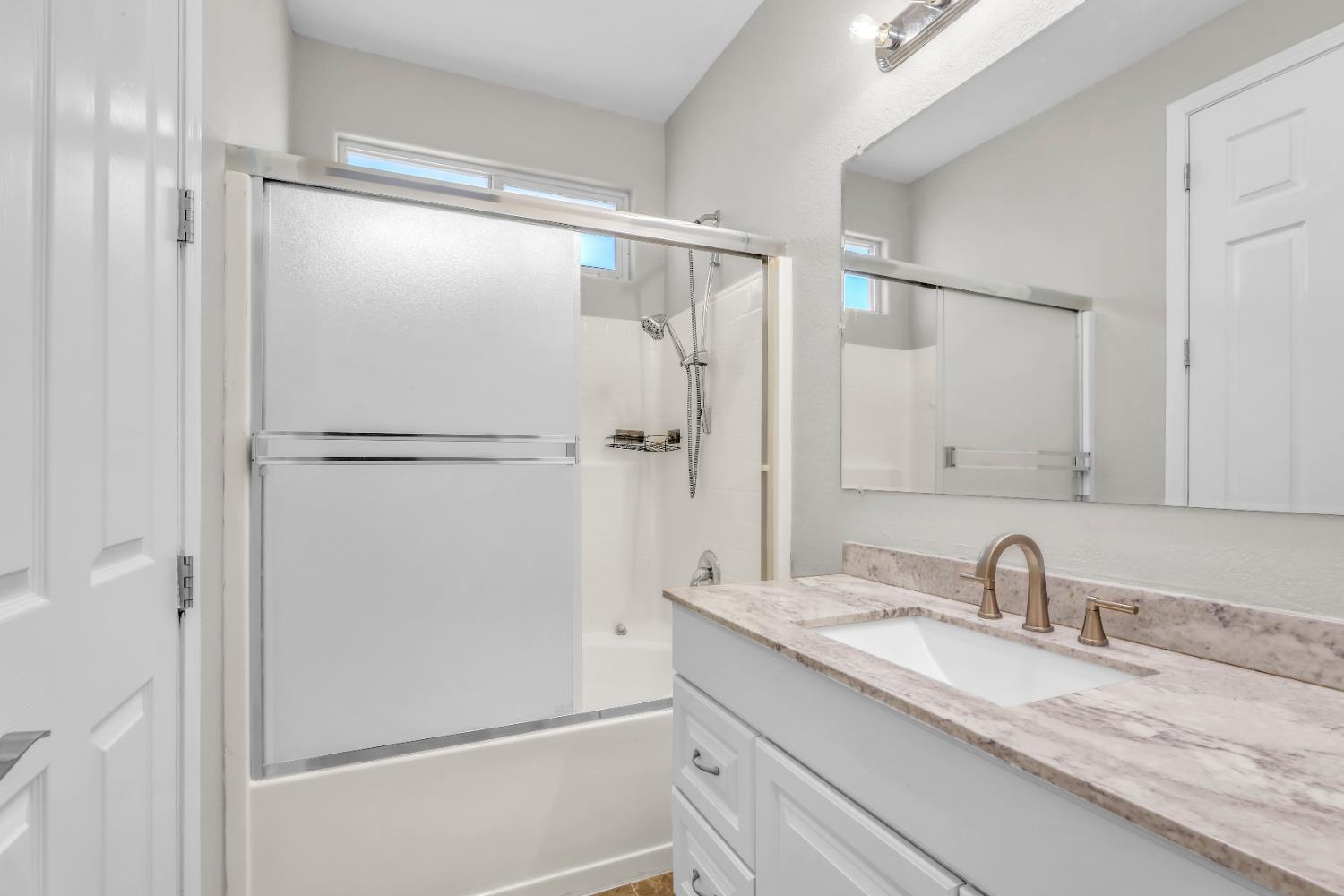 1839 Dawnelle Way Sacramento, CA 95835 - Photo 42 of 56 a bathroom with a granite countertop sink mirror and double