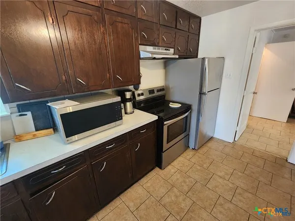 a kitchen with stainless steel appliances a refrigerator and sink