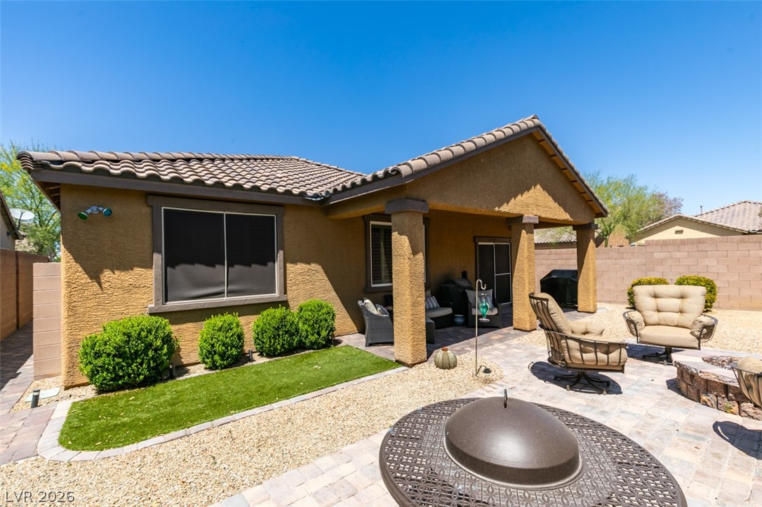 7375 Campbell Ranch Avenue Las Vegas, NV 89179 - Photo 31 of 45 A private desert oasis with an inviting covered patio and fire pit for relaxed outdoor living.