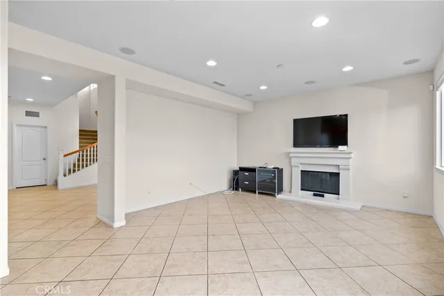 a view of a livingroom with a flat screen tv and fireplace
