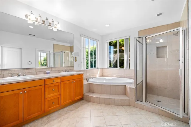 a spacious bathroom with a large tub shower and sink