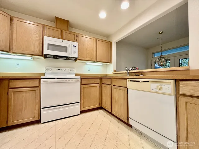 a kitchen with stainless steel appliances white cabinets and a refrigerator