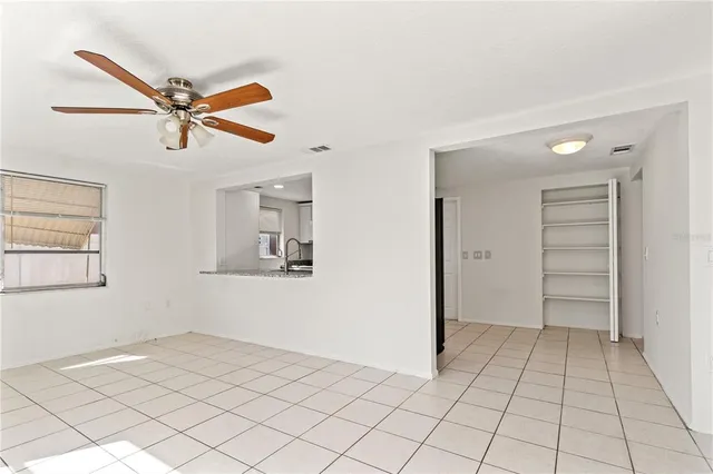a view of a livingroom with a ceiling fan and window